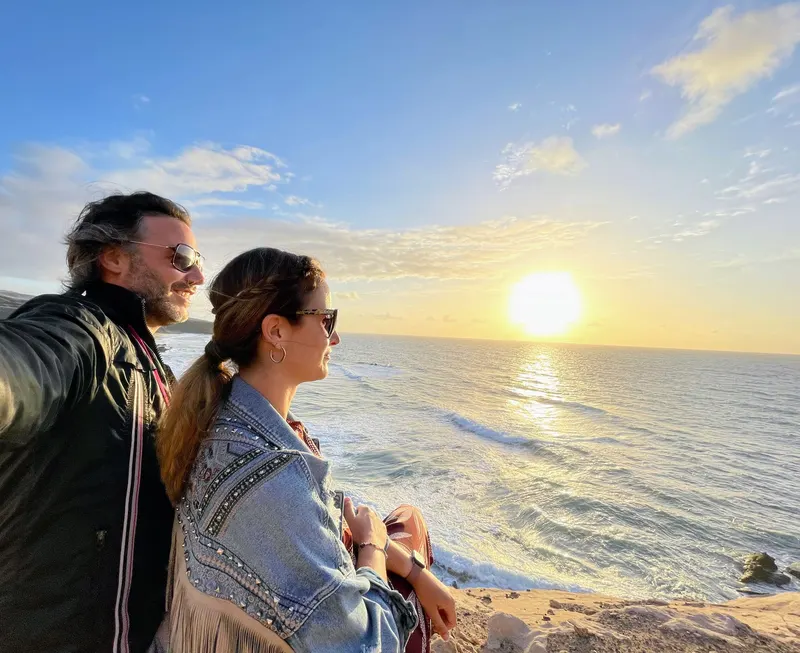 pareja de ThisIsTravel junto con la puesta de sol en la playa de la Pared, Fuerteventura
