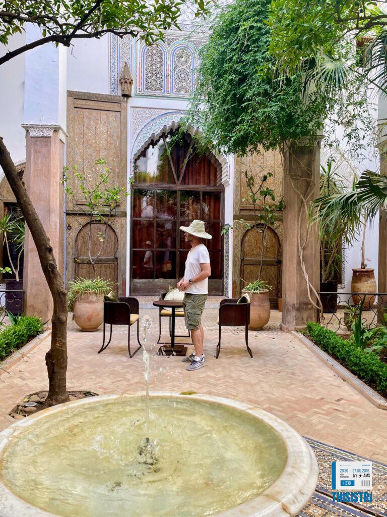 patio interior del Riad Larouusa con jardines y su fuente, con bonita decoración